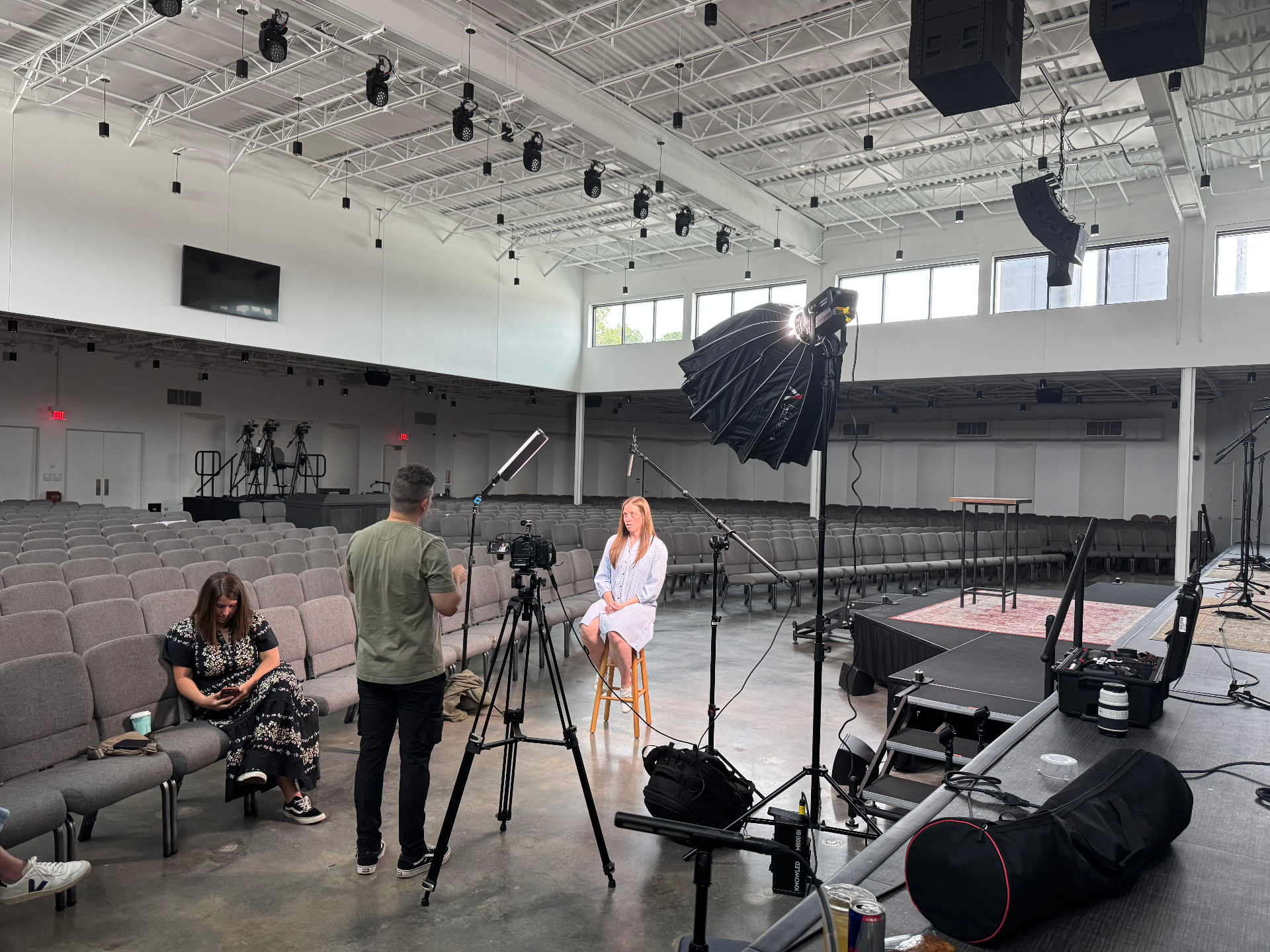 Filming an interview in a large auditorium