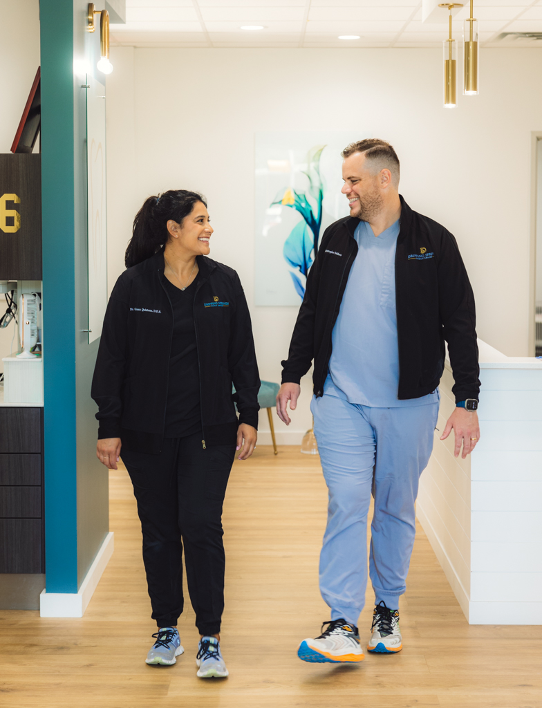 Doctors walking together through a warm, thoughtful practice