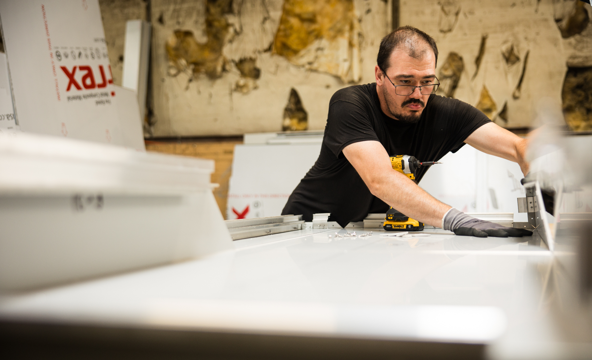 A Build United team member assembling panels on the shop floor