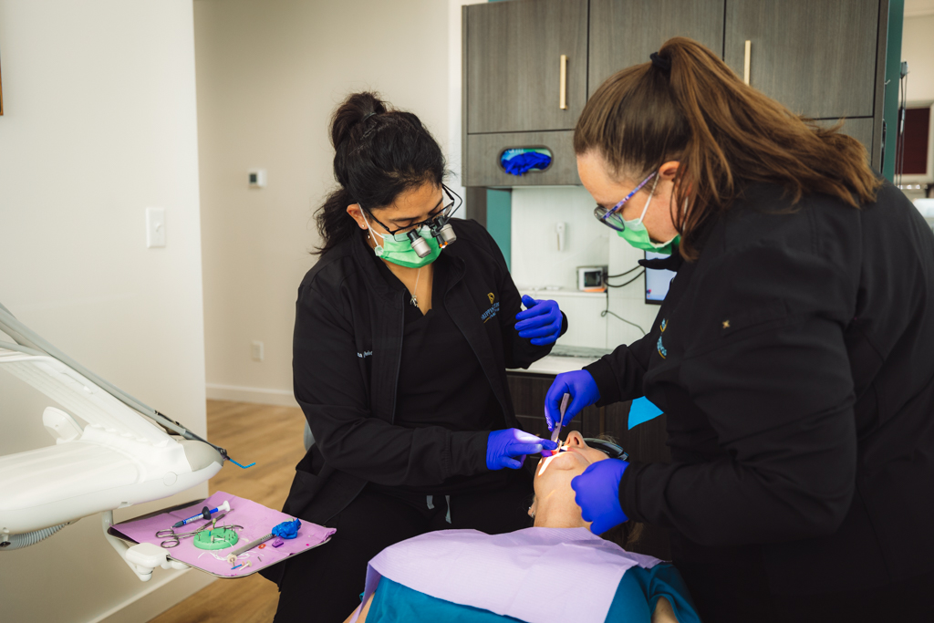 A doctor working attentively with a patient