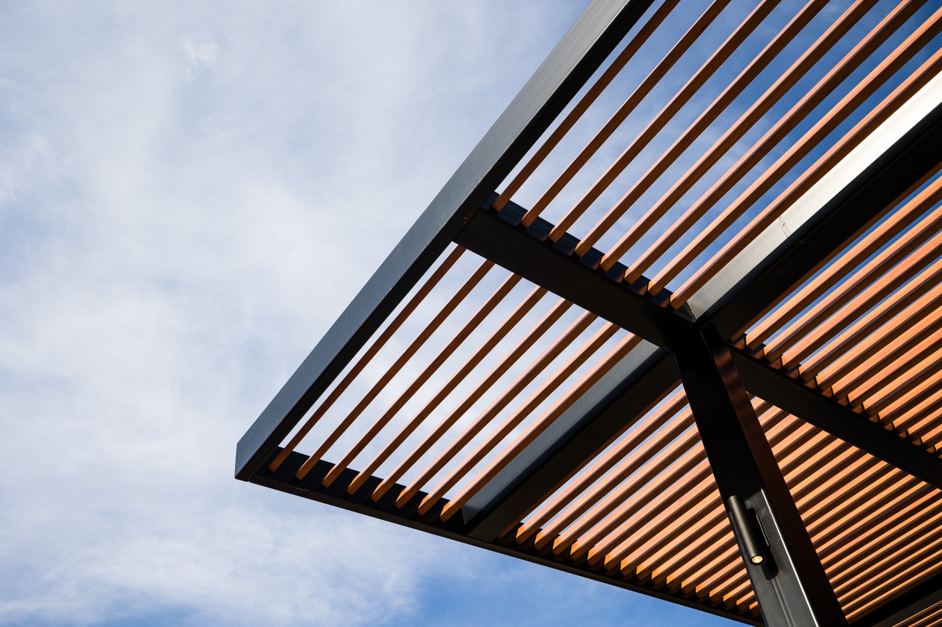 Warm cedar slats set into a blackened steel frame