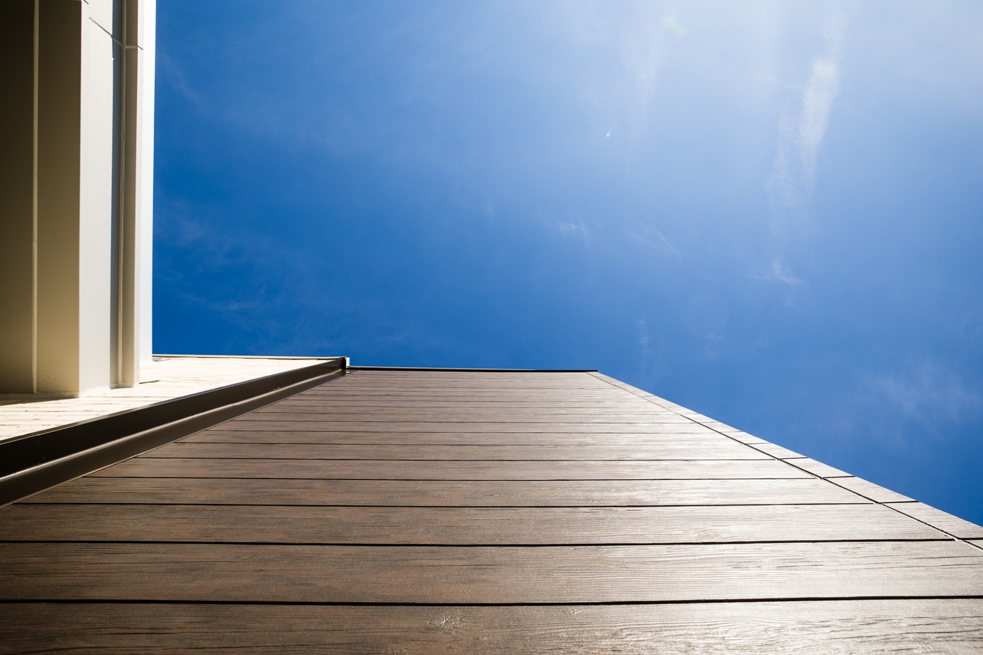 Composite decking rising into a bright sky — a Build United project